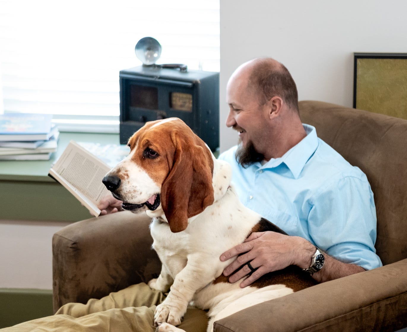 Marlin reading a book with his basset hound