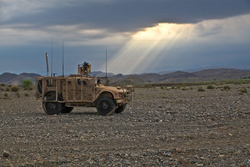 A military vehicle in a desert

Description automatically generated with low confidence
