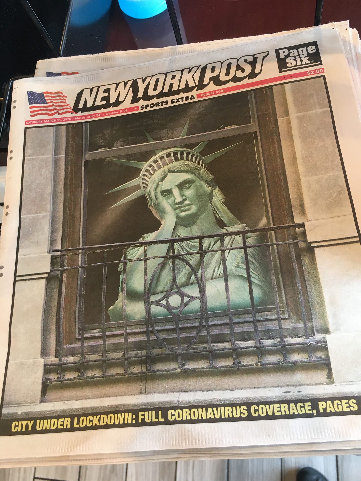 new york post showing the statue of liberty locked in their apartment looking out the window