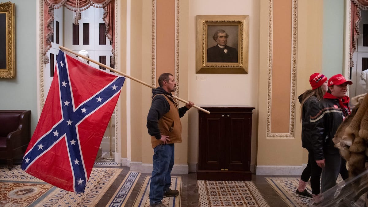 The Confederate battle flag, which rioters flew inside the US Capitol, has  long been a symbol of white insurrection