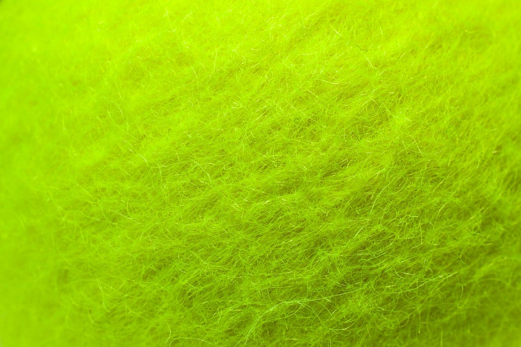 Macro shot of bright green tennis ball felt, Horia Varlan marked with CC BY 2.0