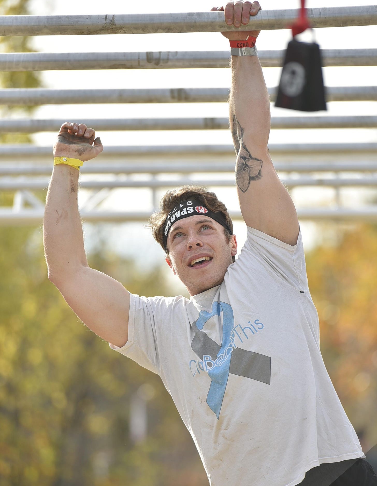 Mastering the monkey bars in a Spartan Race obstacle course. Blue Mountain, Ontario, Canada. October 2021.