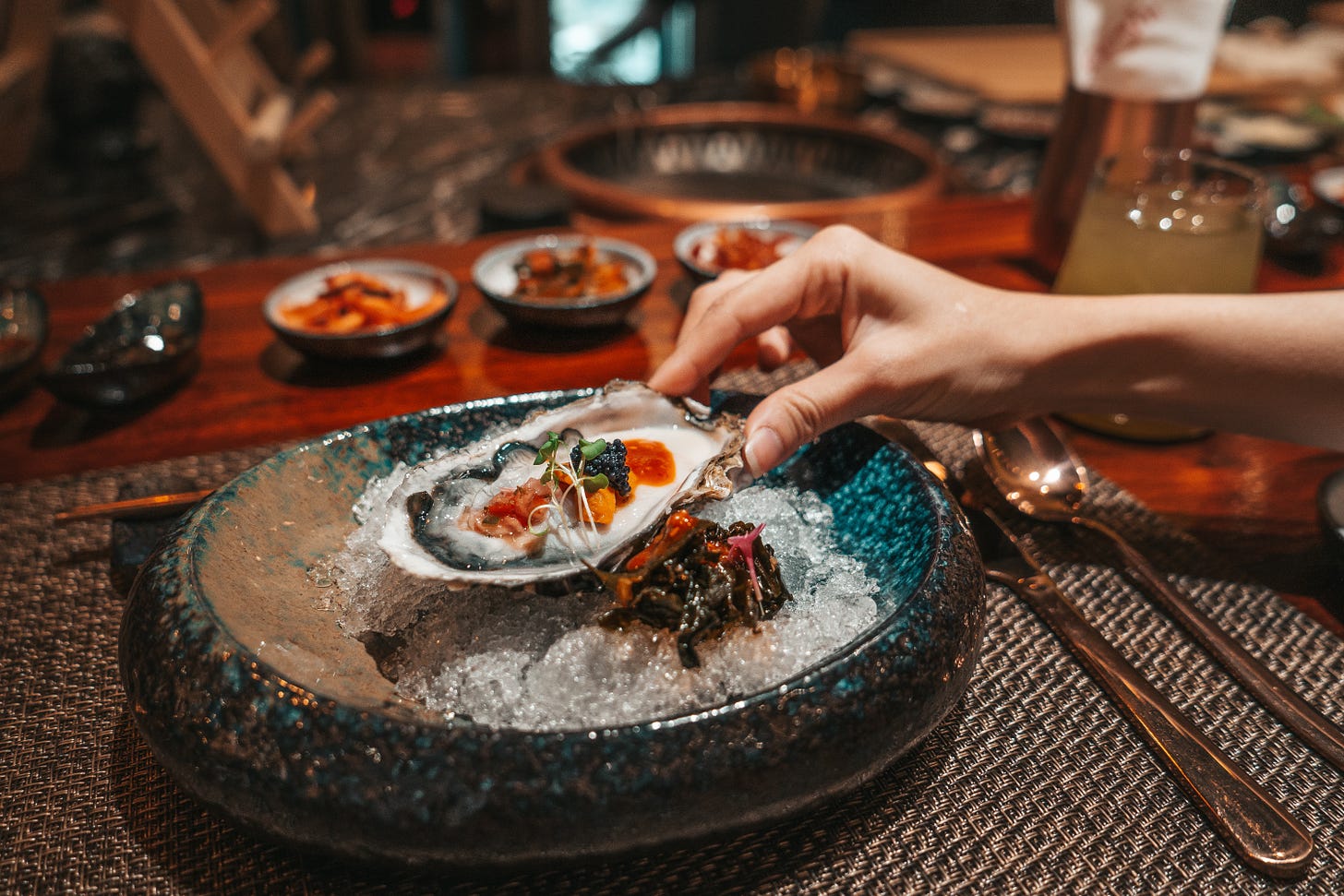 person holding white ceramic plate with food photo