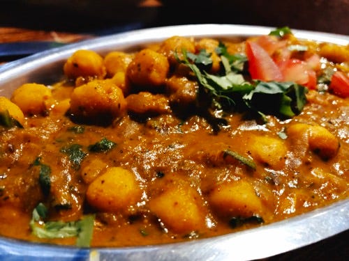 chana masala in a metal dish at namaste india in cabo san lucas.