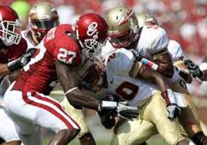 Sam Proctor makes a tackle as a Sooner.  He became an Oklahoma Defender 2.12.2014