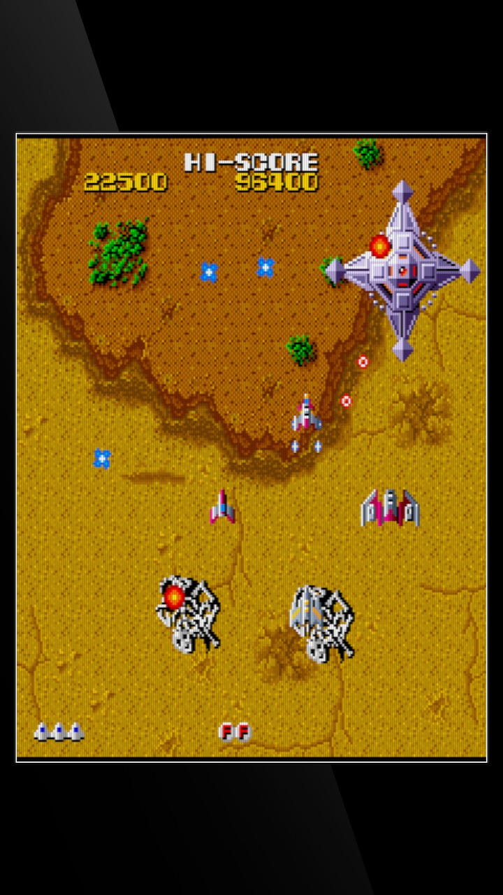 A screenshot captured in the vertical-oriented TATE mode, with dinosaur skeletons, a boss ship, and a four-ship formation.