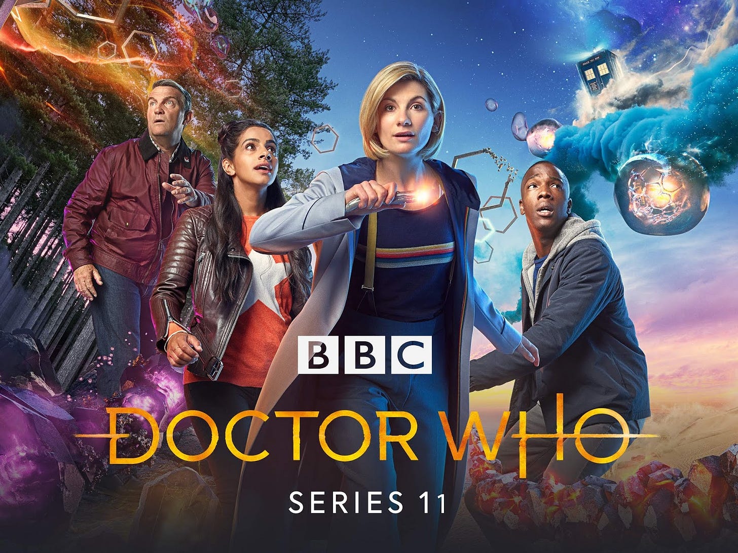 This image shows Doctor Who's Series 11 one-sheet poster. The Thirteenth Doctor (played by Jodie Whittaker) stands in the image's center holding her sonic screwdriver, while companions Graham O'Brien (played by Bradley Walsh) and Yasmin "Yaz" Khan (played by Mandip Gill) are seen behind and to the Doctor's left. Companion Ryam Sinclair (played by Tosin Cole) and the TARDIS are seen behind and to the Doctor's right. Below the Doctor are the BBC's and Doctor Who's official logos, as well as the words "Series 11." This image shows Doctor Who's Series 11 one-sheet poster. The Thirteenth Doctor (played by Jodie Whittaker) stands in the image's center holding her sonic screwdriver, while companions Graham O'Brien (played by Bradley Walsh) and Yasmin "Yaz" Khan (played by Mandip Gill) are seen behind and to the Doctor's left. Companion Ryam Sinclair (played by Tosin Cole) and the TARDIS are seen behind and to the Doctor's right. Below the Doctor are the BBC's and Doctor Who's official logos, as well as the words "Series 11."