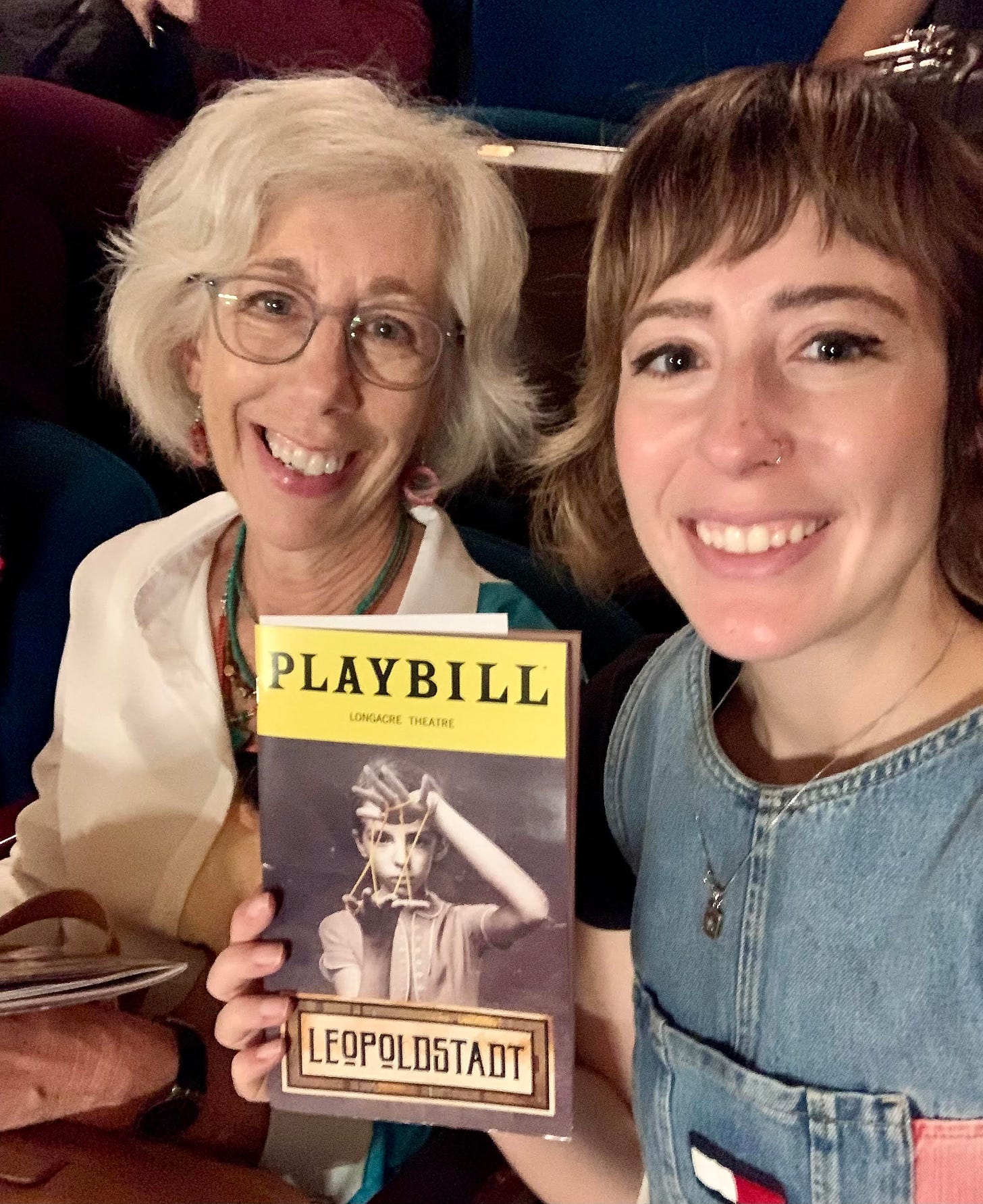 My mom and me smiling and holding playbill