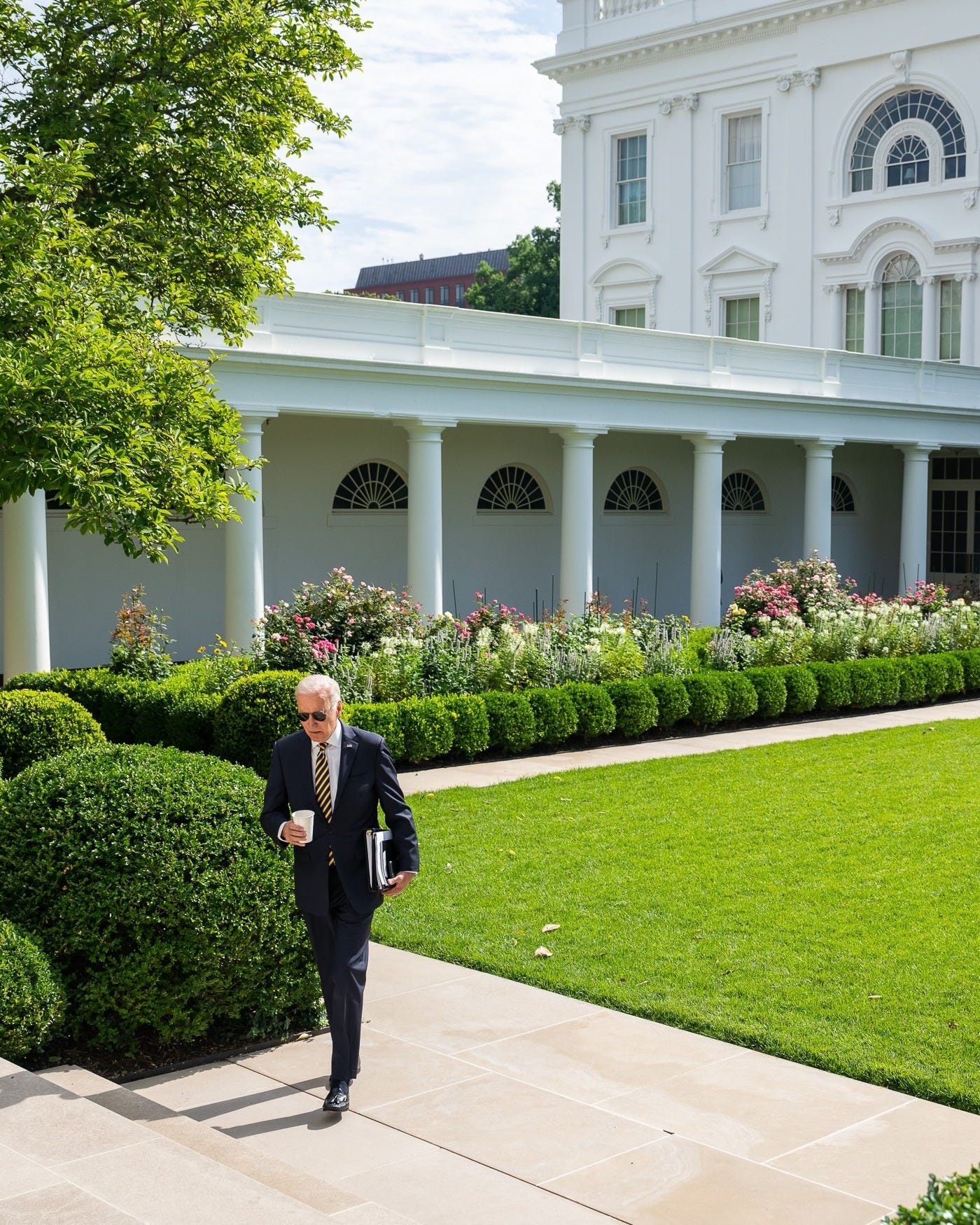 President Biden walks towards the Oval Office.