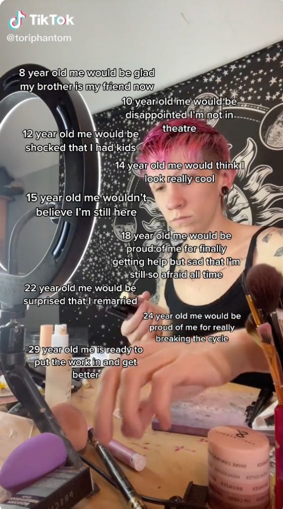 A video of a TikToker sitting at their desk starting to do their makeup. A mellow song plays in the background, and several lines of text over the video chronical how their past self would feel about their current self. (I won't add all the lines of text because there are too many, but for example: "10 year old me would be disappointed I'm not in theatre.")