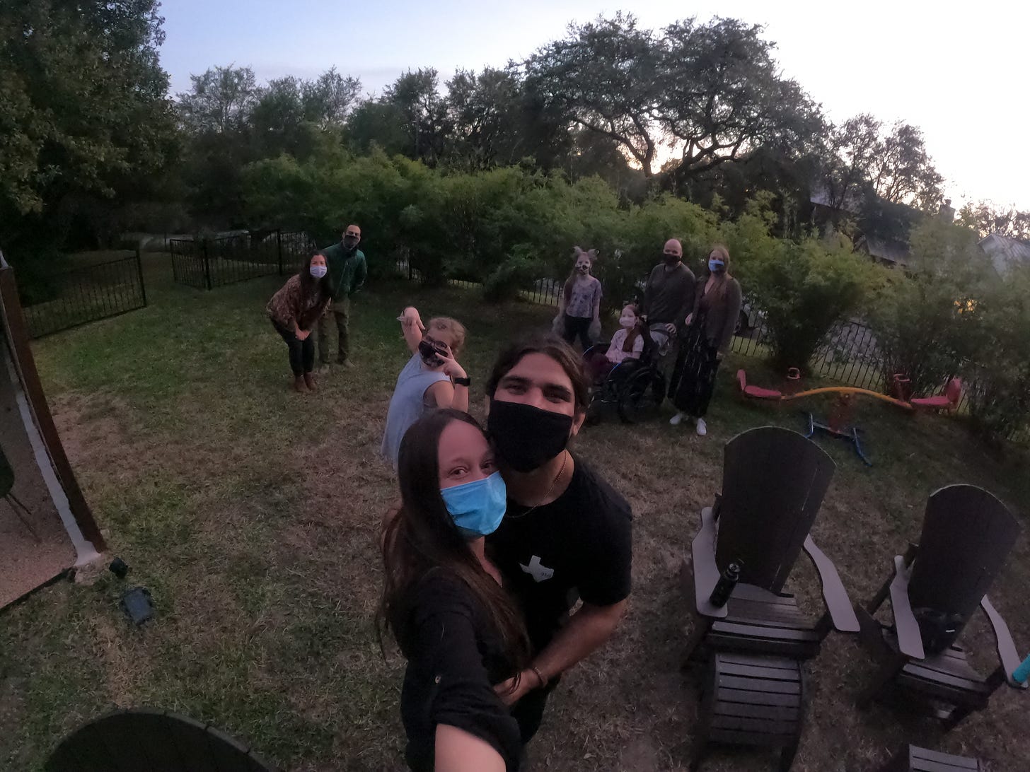 Anthony and Kelly stand and selfie with the backyard audience everyone is wearing masks!