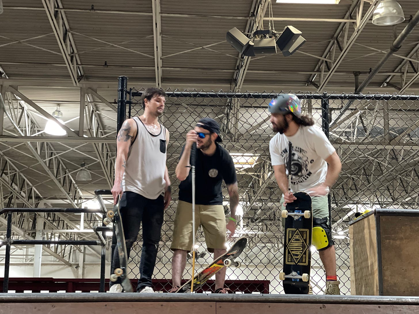 Blind Skaters, Nick Mullins (left), Justin Bishop (middle) and Anthony Ferraro talk at the top of a mini pipe