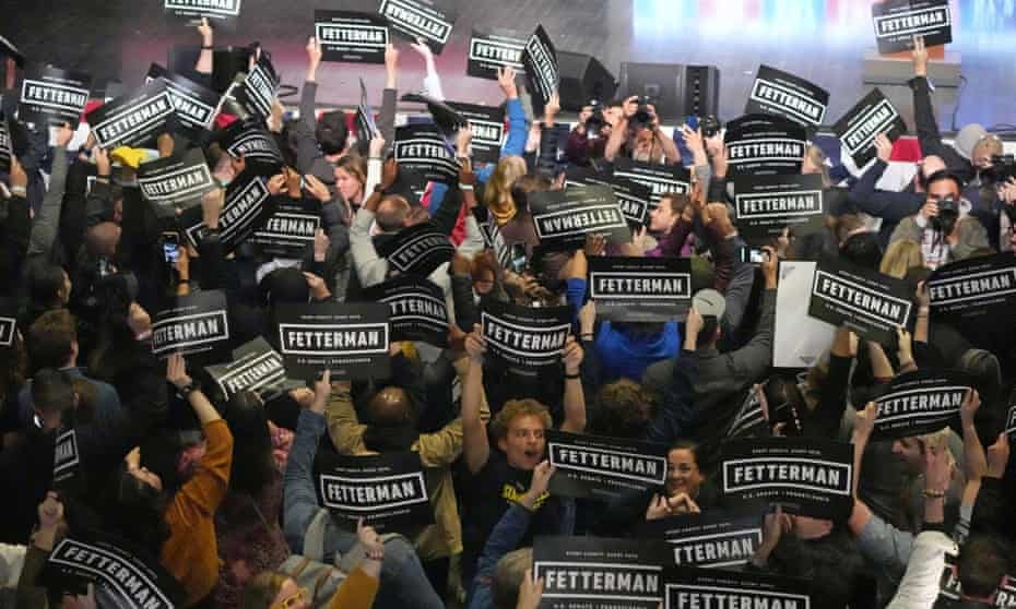 overhead view of lots of people holding up signs for fetterman