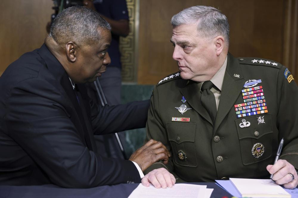 FILE - In this June 17, 2021 file photo, Secretary of Defense Lloyd Austin, left, and Chairman of the Joint Chiefs Chairman Gen. Mark Milley talk before a Senate Appropriations Committee hearing on Capitol Hill in Washington. In their first public testimony on Afghanistan since the U.S. completed its withdrawal on Aug. 30, Austin and Milley are appearing before the Senate Armed Services Committee on Tuesday, along with Gen. Frank McKenzie, who as head of Central Command oversaw the withdrawal as well as an Aug. 29 drone strike that he later called a tragic mistake. (Evelyn Hockstein/Pool via AP)