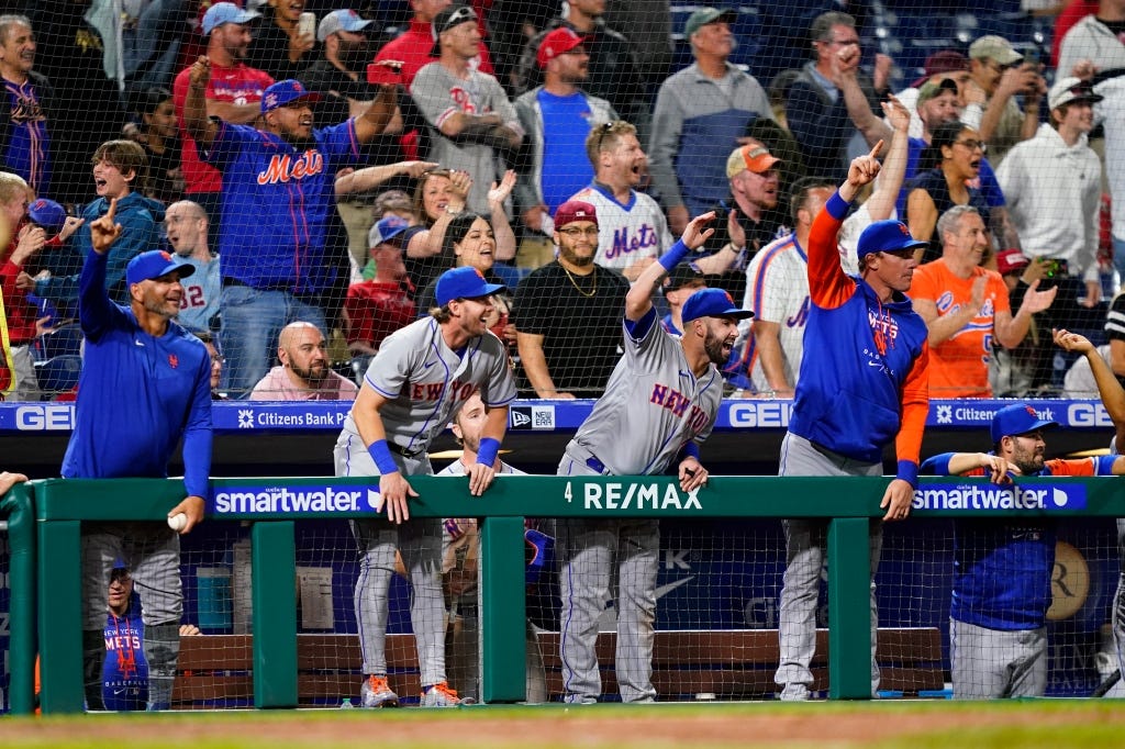 Mets celebrates in the dugout during their ninth-inning rally.
