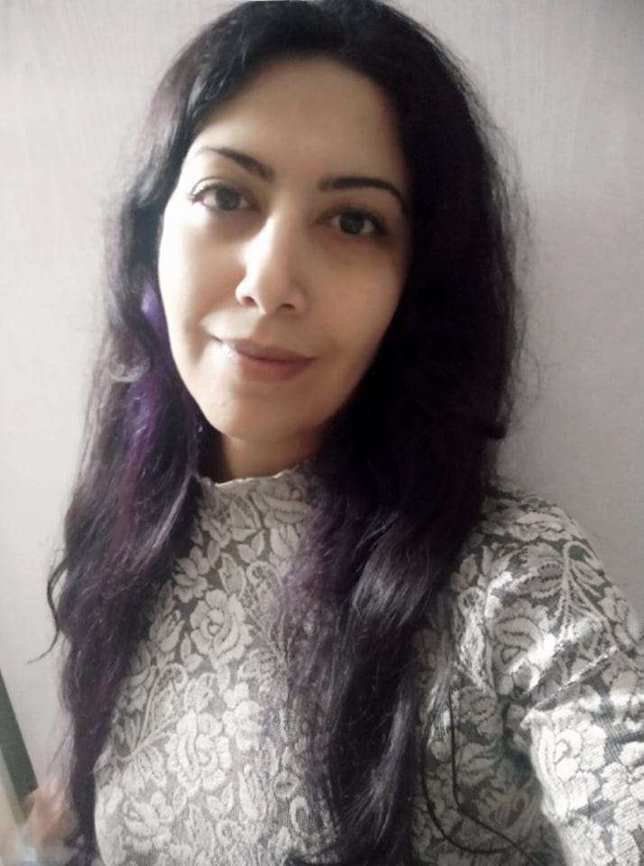 Portrait of a woman wearing a white flowery top