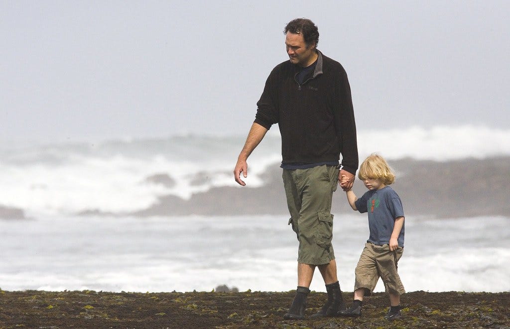 Man walking young son along the beach (image courtesy of Thomas Hawk on Flickr)