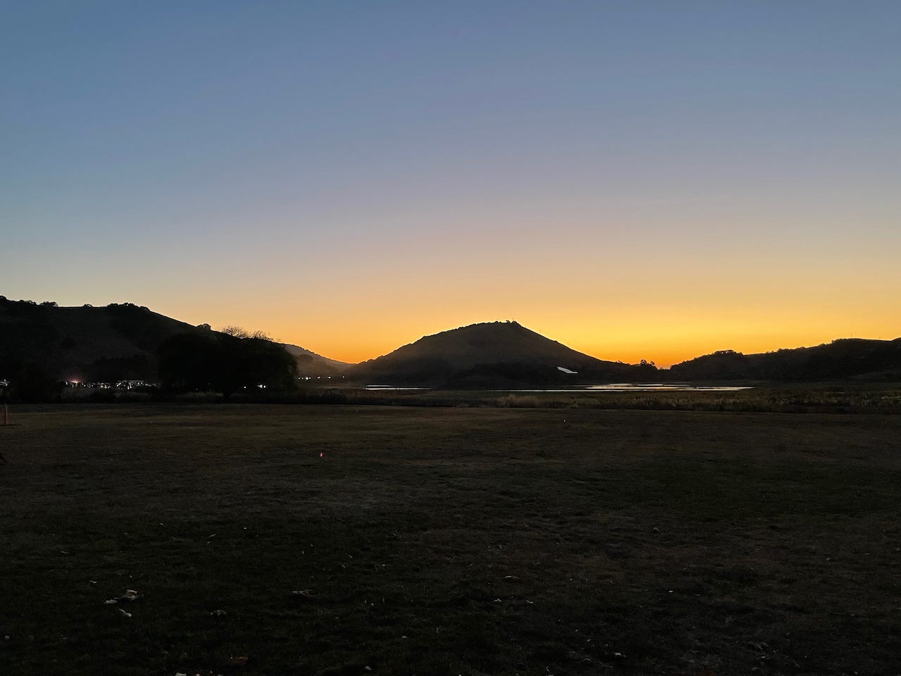 photo by arod of the sun rising over the hills at Stafford Lake in Novato California