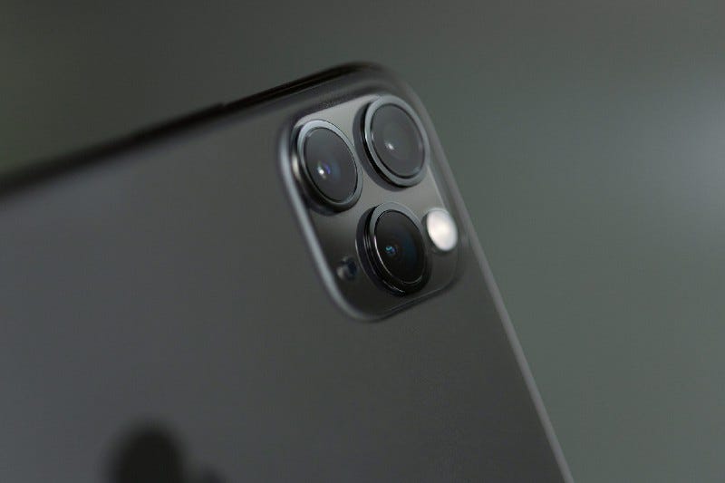 Close-up of an iPhone with three camera lenses.