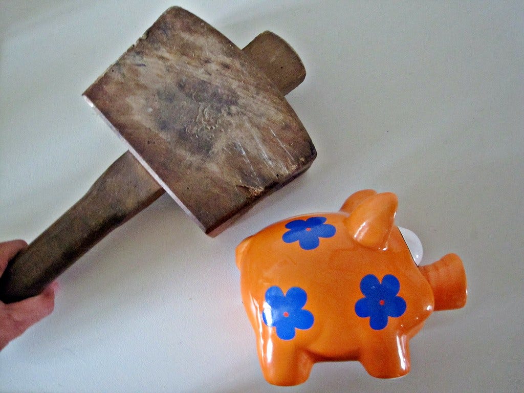 "Smashing a Piggy Bank" by Images_of_Money is licensed under CC BY 2.0