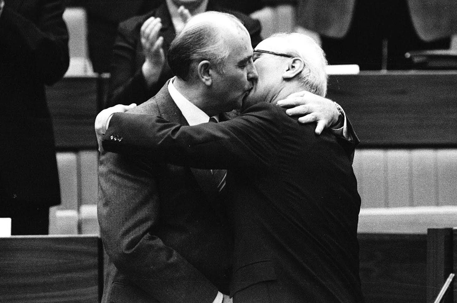 The Soviet leader Mikhail Gorbachev congratulates East German leader Erich Honecker with a fraternal hug and kiss after Honecker's re-election as the head of the Communist Party Congress in East Berlin, on April 21, 1986. 