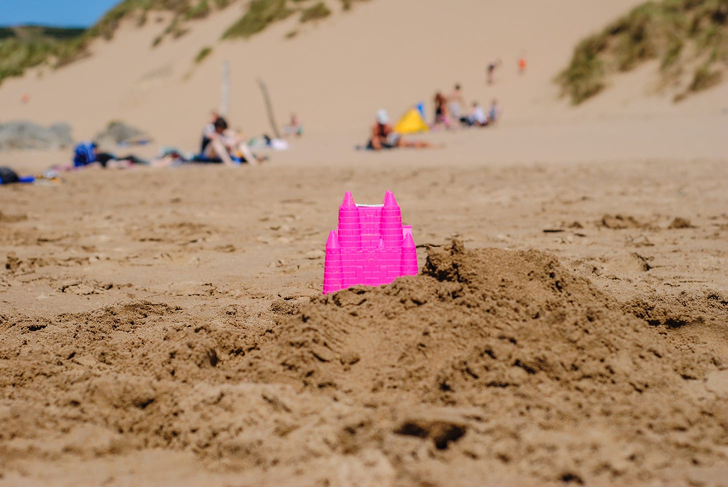 Pink castle toy in shore at daylight