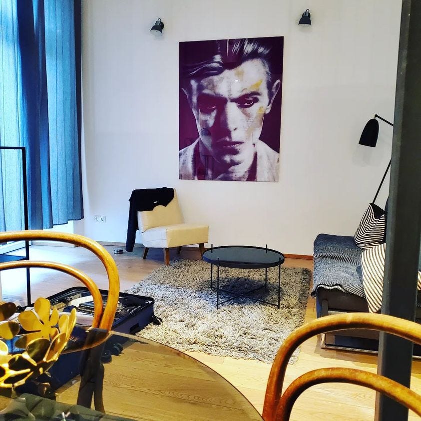 A black and white poster of Bowie dominates a wall in an apartment decorated in Ikea kitsch. 