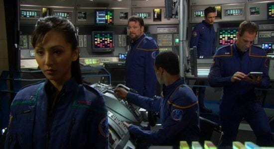 This image shows Commander William Riker (played by Jonathan Frakes) dressed as a member of Jonathan Archer's NX-01 Enterprise crew as he stands on that ship's bridge. Sitting or standing from left to right are Communications Officer Hoshi Sato (played by Linda Park), Riker, Helmsman Travis Mayweather (played by Anthony Montgomery), Armory Officer Malcolm Reed (played by Dominic Keating), and Archer (played by Scott Bakula). This image shows Commander William Riker (played by Jonathan Frakes) dressed as a member of Jonathan Archer's NX-01 Enterprise crew as he stands on that ship's bridge. Sitting or standing from left to right are Communications Officer Hoshi Sato (played by Linda Park), Riker, Helmsman Travis Mayweather (played by Anthony Montgomery), Armory Officer Malcolm Reed (played by Dominic Keating), and Archer (played by Scott Bakula).