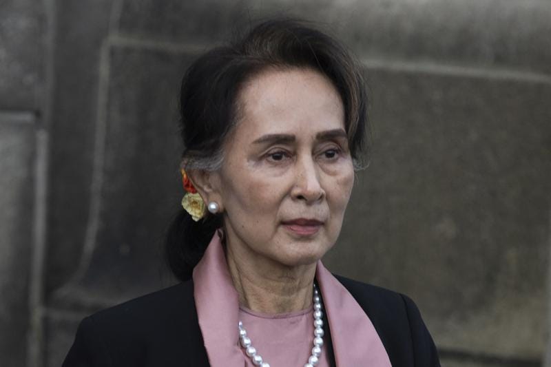 FILE - Myanmar's leader Aung San Suu Kyi leaves the International Court of Justice after the first day of three days of hearings in The Hague, Netherlands on Dec. 10, 2019. A court in military-ruled Myanmar has postponed a verdict on Monday, Dec. 27, 2021 in a case against ousted leader Aung San Suu Kyi in which she is charged with importing and possessing walkie-talkies without following official procedures, a legal official familiar with the case said. (AP Photo/Peter Dejong, File)