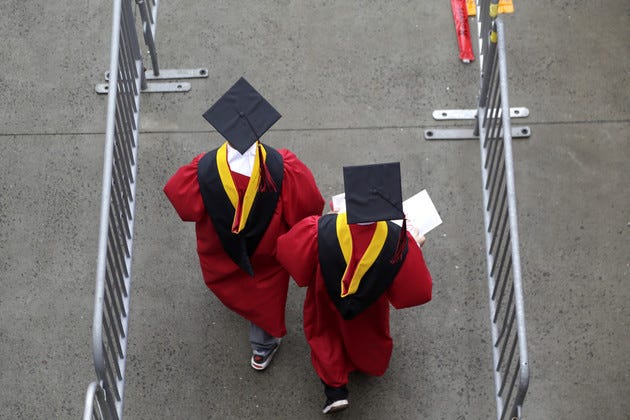 New graduates walk into the High Point Solutions Stadium before the start of the Rutgers University graduation ceremony.