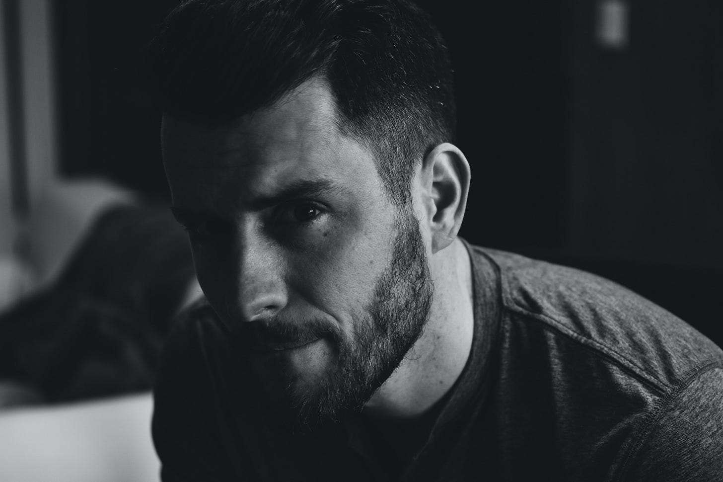 Black and white profile photo of a handsome bearded man