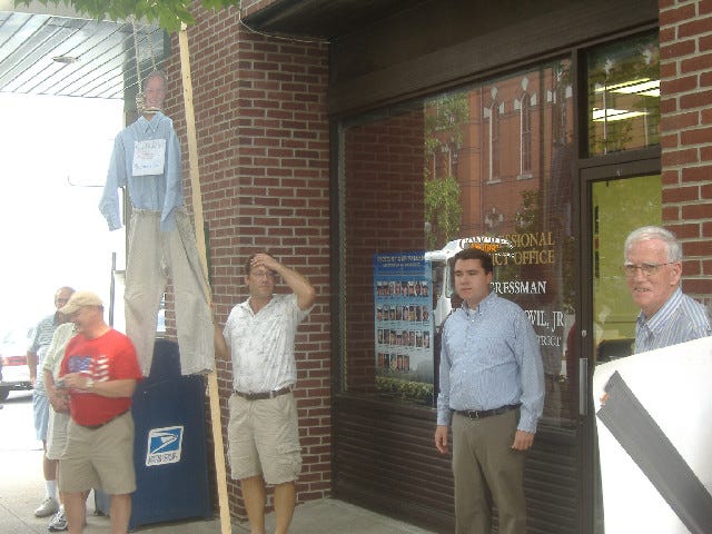 Kevin Lawlor, Kratovil's Communications Director, emerges from the office to speak with the gathering.