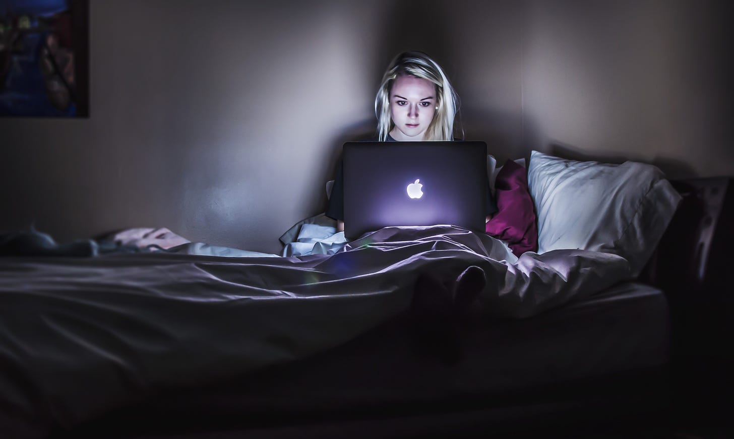 girl on laptop in bed