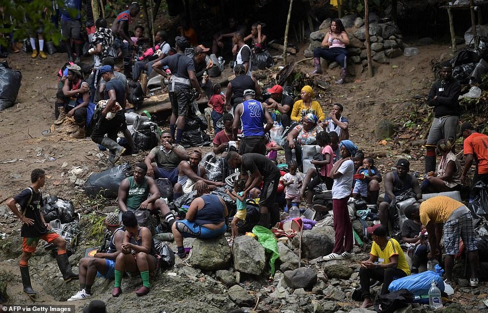 Thousands of migrants continue attempt to make their way from South America to the U.S. borders (Pictured: Migrants crossing the Darien Gap near Acandi)