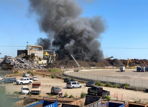 A fire burns in a metal scrap pile at Schnitzer Steel along the Embarcadero near Adeline Street in Oakland, Calif., on Saturday, June 2, 2018. Billowing black smoke could be seen for miles as Oakland firefighters worked to extinguish the blaze which began shortly before 4:00 p.m. (Jane Tyska/Bay Area News Group)
