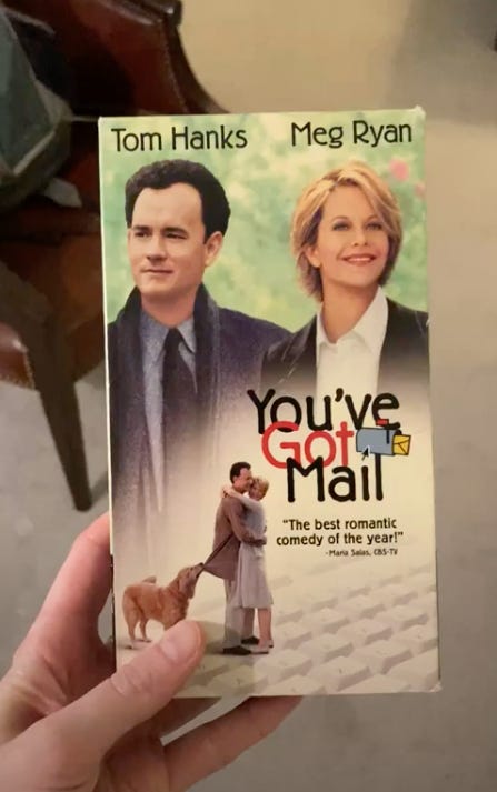VHS cassette tape cover with Tom Hanks and Meg Ryan pictures standing side by side in a park, with video title "You've Got Mail" and AOL mailbox icon
