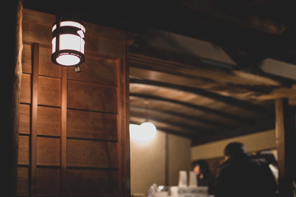 A lantern provides illumination at WEEKENDERS, Tominokoji.