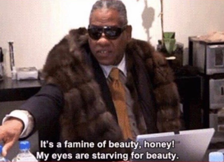 A screenshot from a video of Andre Leon Talley, a black man with grey hair, in a voluptuous fur coat and large shades. The caption reads 'It's a famine of beauty, honey! My eyes are starving for beauty.'