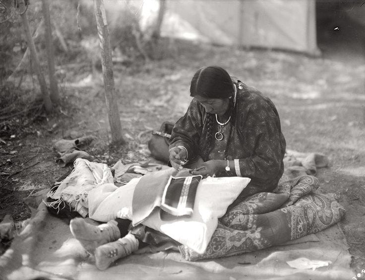 Crow woman working on leggings for her husband. Making of garents was exclusively womans job.