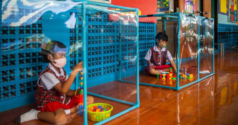 Photos: Thai Students Encased In Plexiglass As Schools ...