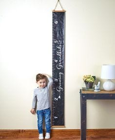 Track your child's height with this Sentiment Ruler Growth Chart. It will add a touch of love home decor and stir up fond memories in later years. The flexible banner has a wood accent at the top and bottom, along with a hanger. Measurements: 7-5/8 in. wide x 5 ft. 11-3/4 in. long