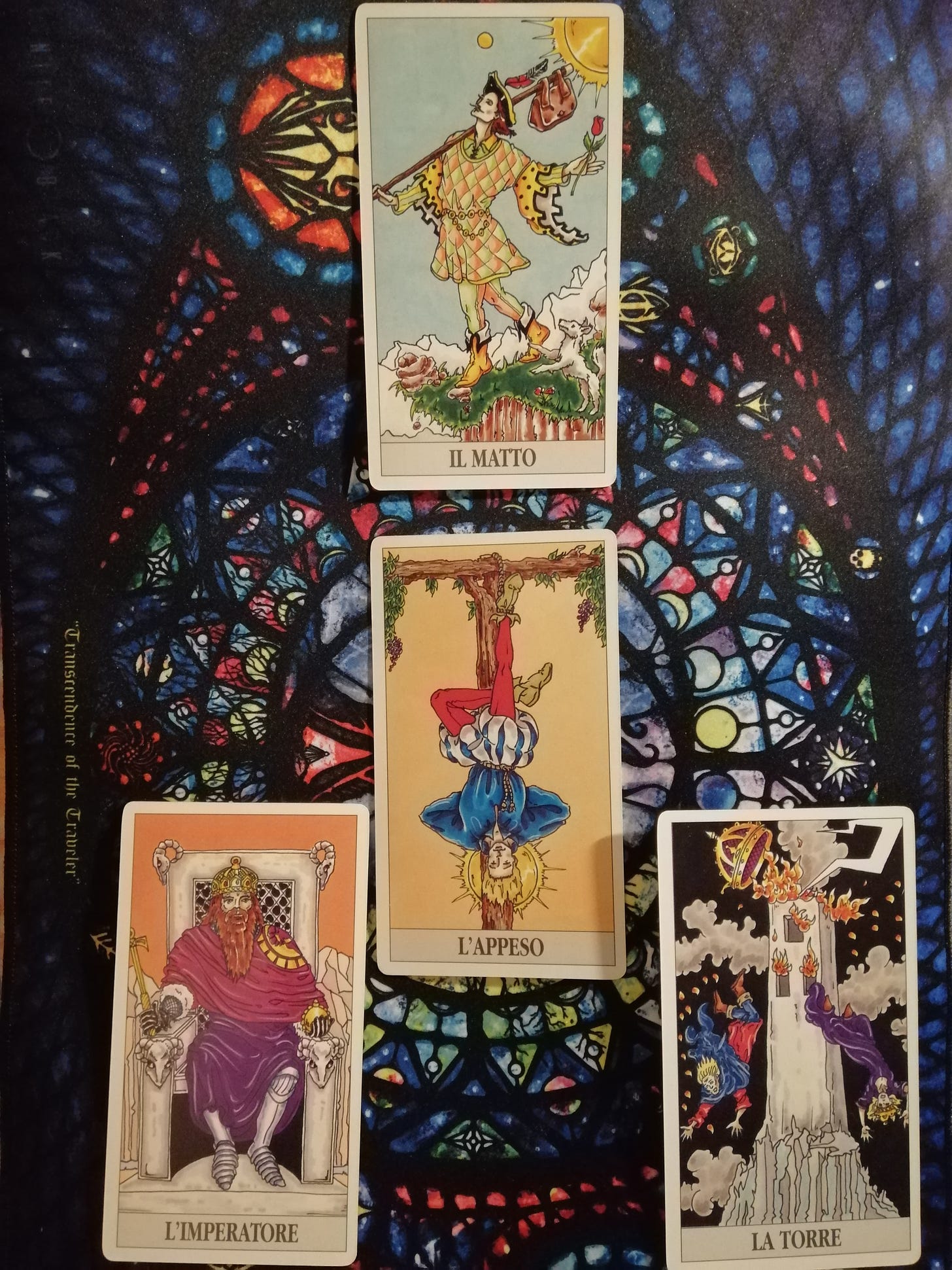 A Spread with the La Zingara Tarot deck: at the center L'Appeso ("the Hanged Man"), then clockwise from the bottom right La Torrr ("the Tower"), L'imperatore ("the Emperor"), and Il Matto ("the Fool") 