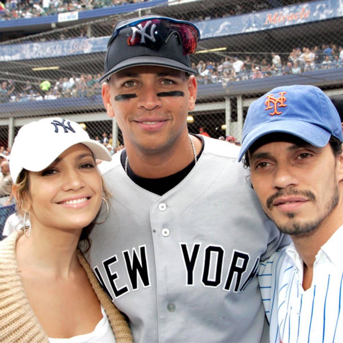 Jennifer Lopez in a Yankees hat and Marc Anthony in a Mets hat posing with A-Rod during the subway series
