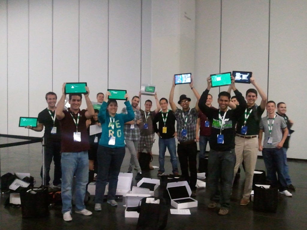 groups of about 18 interns holding up their Samsung PCs. Some are powered on and ready to go.