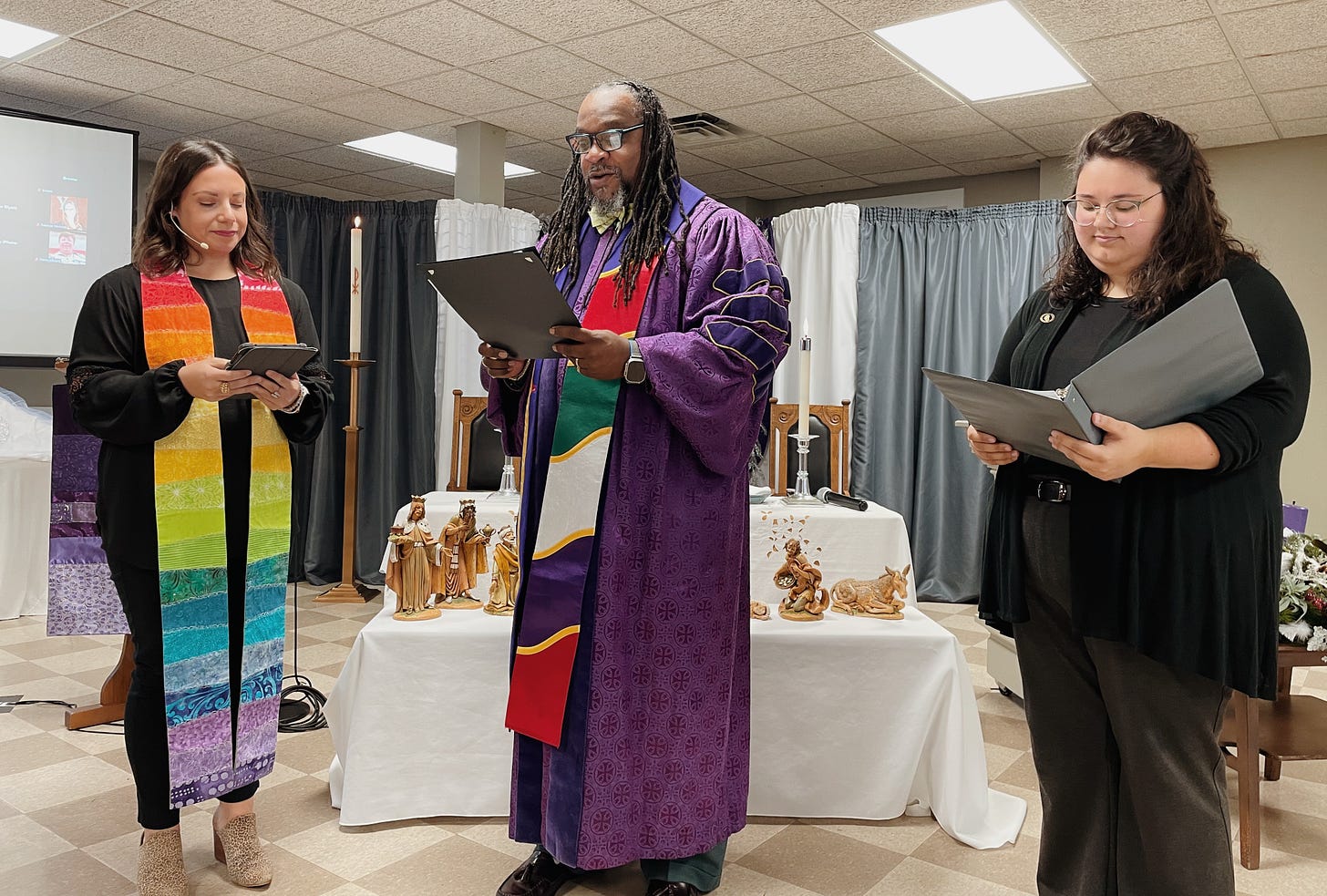 Chloe is pictured in a worship service with two other pastors during her installation at the congregation that she serves. 