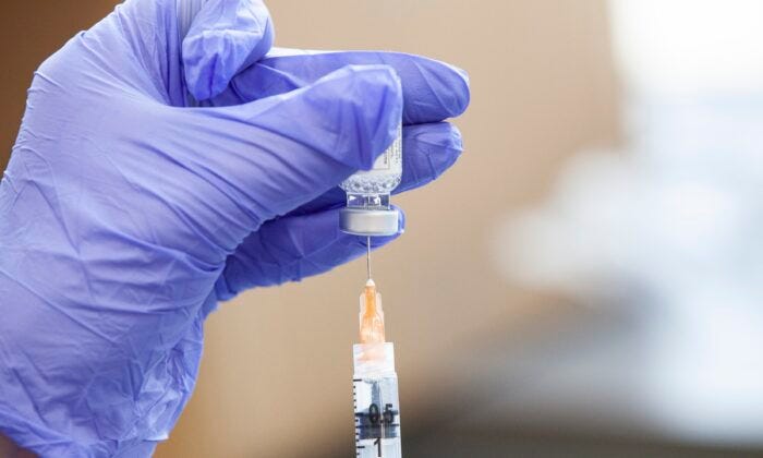 A COVID-19 vaccine is prepared in a file image. (Stephen Zenner/Getty Images)