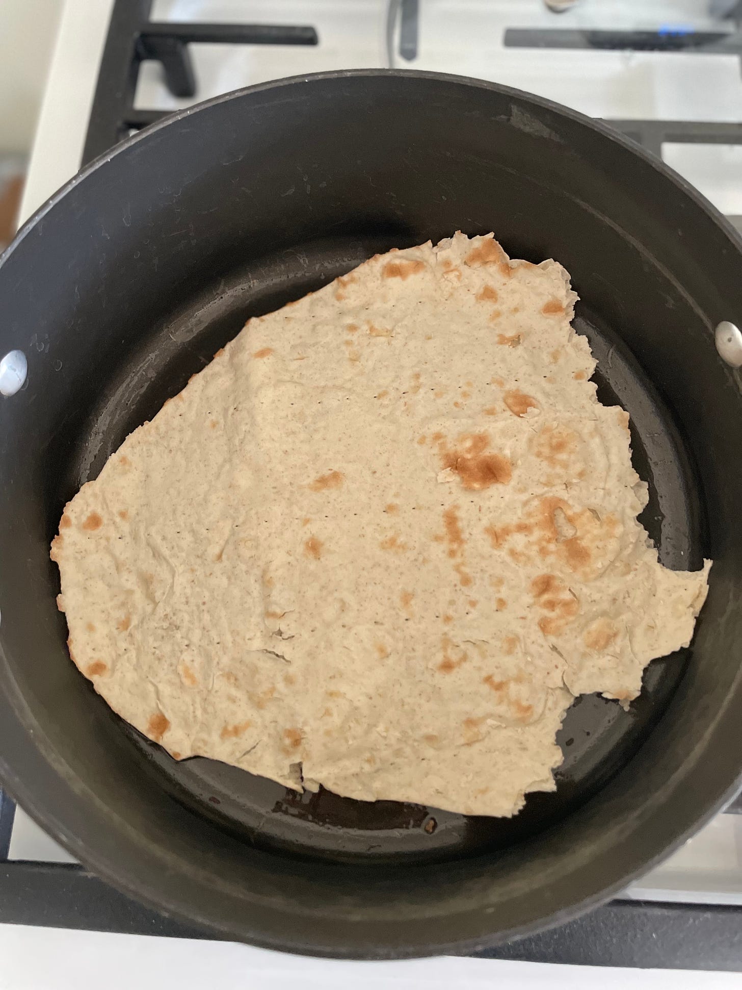 Lavash at bottom of pot on oil