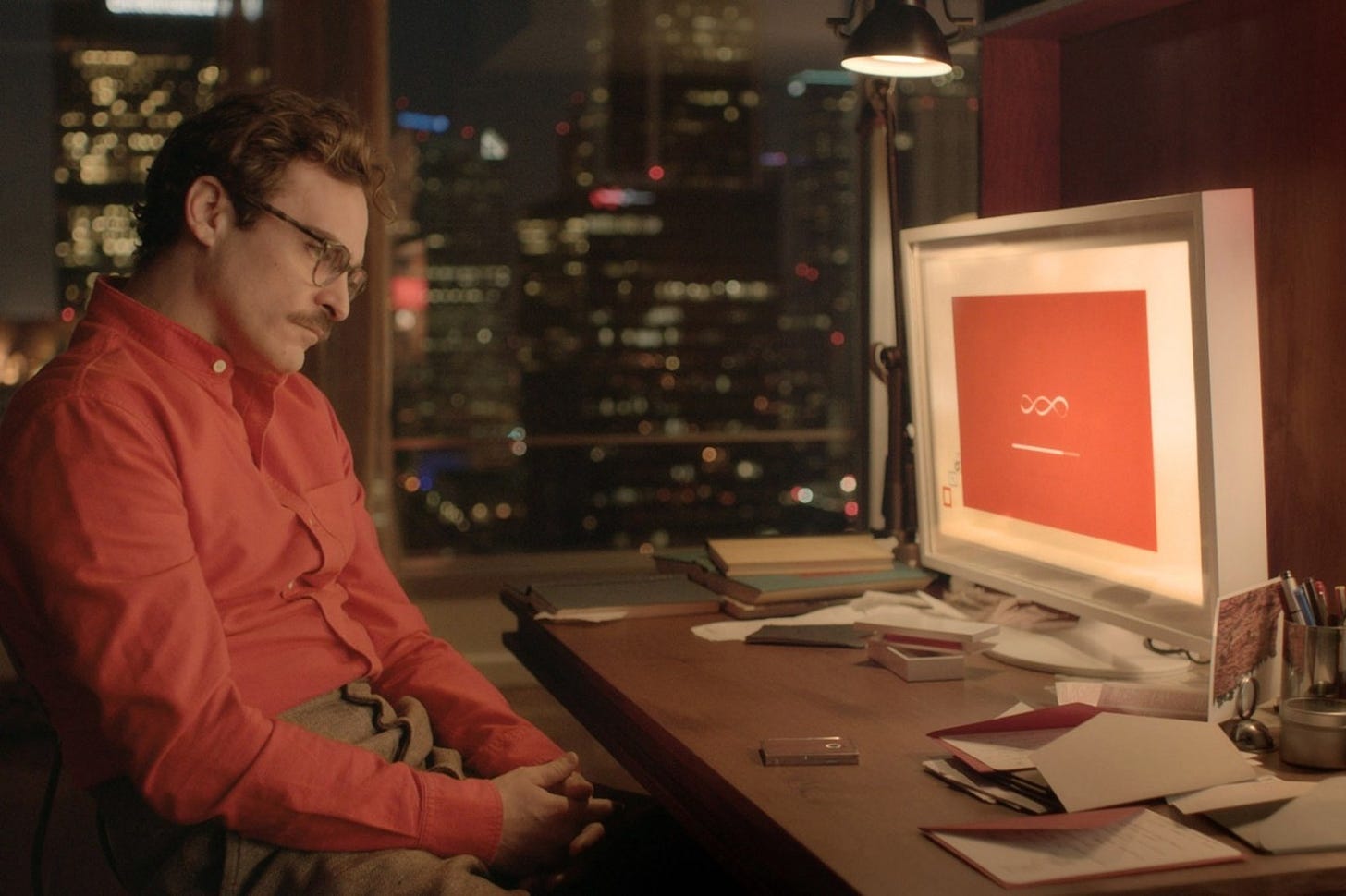 Main character of movie “Her” is looking at his computer operating system.