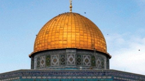 People walk outside as birds circle atop the Dome of the Rock shrine at the Aqsa mosque compound ...