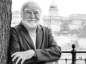 Image of mihaly csikszentmihalyi leaning against a tree